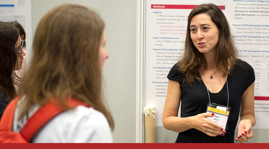 Woman at conference talking to others